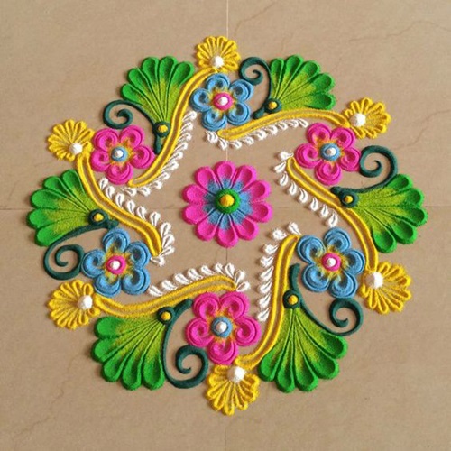 Simple rangoli design of flower with pink ,green and yellow color